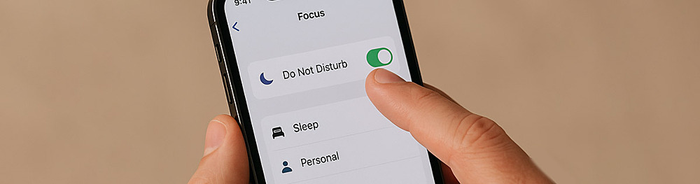 A close up of someone flicking their smartphone to Do Not Disturb